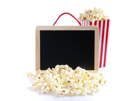 Popcorn and blackboard on a wooden table