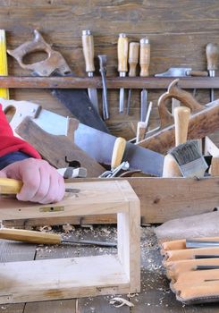 Carpenter working wood on the workbench carpentry.