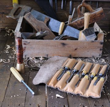 Different tools on wooden floor in garage