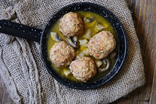 meatballs in a pan over wooden table in the kitchen