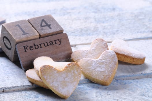 Homemade cookies for valentines day over wooden table
