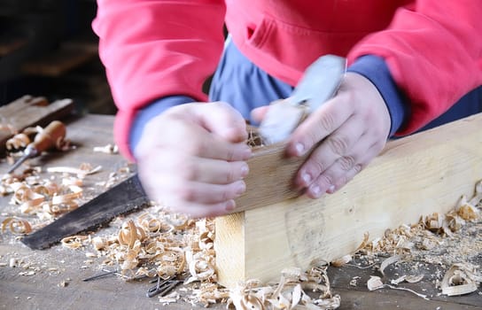 Carpenter working wood on the workbench carpentry.