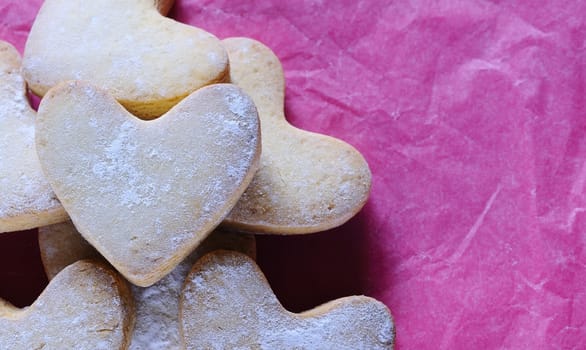 Homemade cookies for valentines day over wooden table