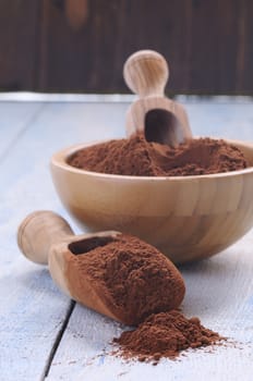 Cocoa powder on wooden table in the kitchen