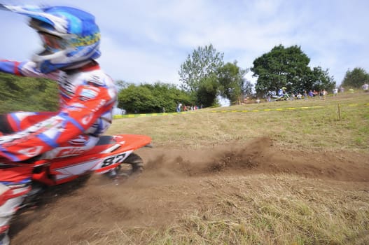 Motocross rider on a muddy track