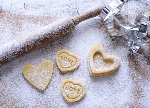 Homemade cookies for valentines day over wooden table