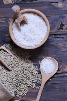 Lentils and rice on wooden table in the kitchen.