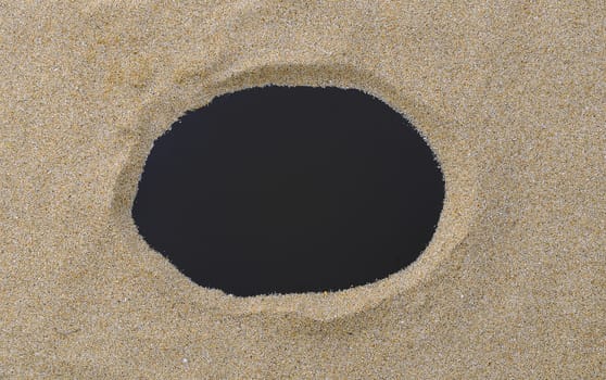 Blackboard with copy space on beach sand.