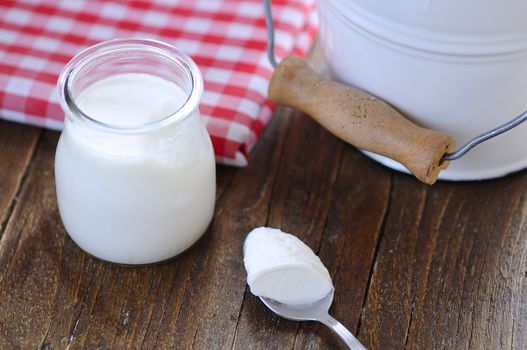 Close-up of jar with sour cream on wooden table