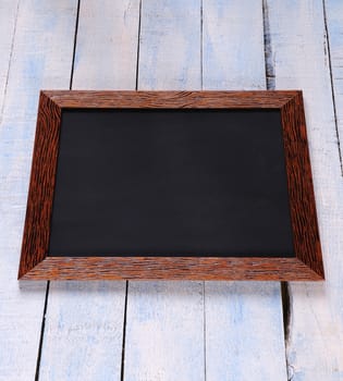 Blackboard on a old wooden wall.