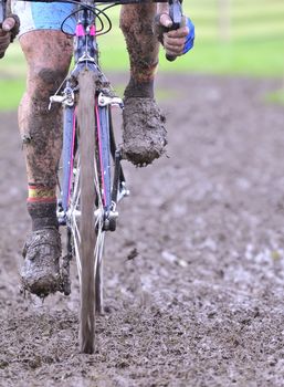 Detail bicycle chain with mud in a race