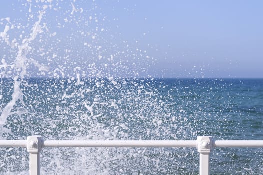 Waves breaking on the promenade in the city of Gijon
