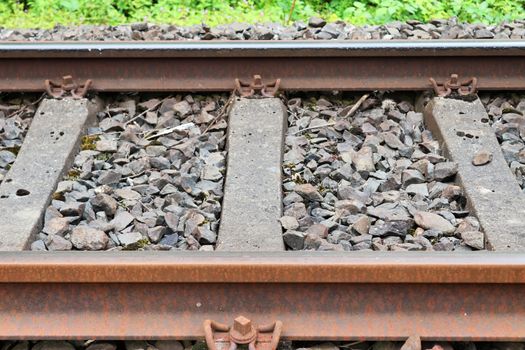 Multiple railroad tracks with junctions at a railway station in a perspective view