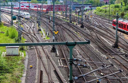 Multiple railroad tracks with junctions at a railway station in a perspective view