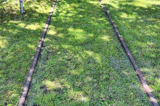 Multiple railroad tracks with junctions at a railway station in a perspective view