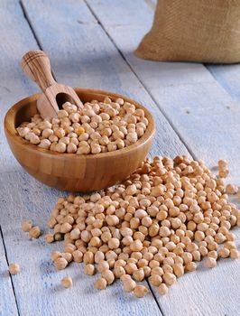 Tasty chickpeas prepared for cooking on wooden table.