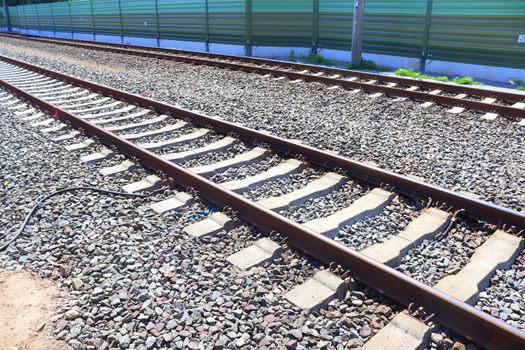 Multiple railroad tracks with junctions at a railway station in a perspective view