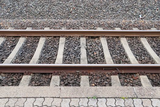 Multiple railroad tracks with junctions at a railway station in a perspective view