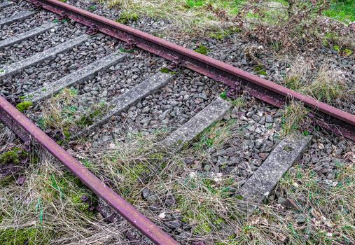 Multiple railroad tracks with junctions at a railway station in a perspective view