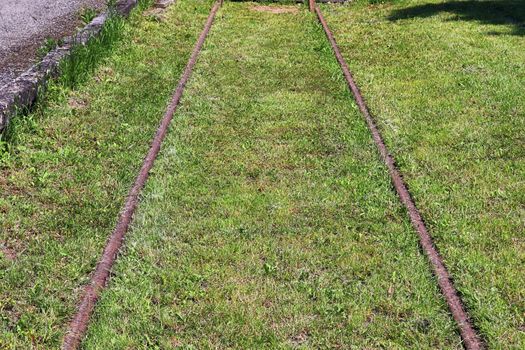 Multiple railroad tracks with junctions at a railway station in a perspective view