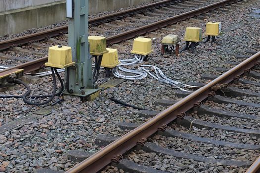 Multiple railroad tracks with junctions at a railway station in a perspective view