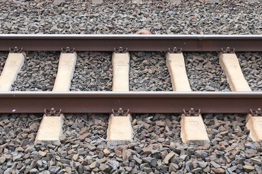 Multiple railroad tracks with junctions at a railway station in a perspective view