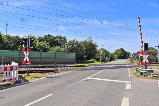 Multiple railroad tracks with junctions at a railway station in a perspective view