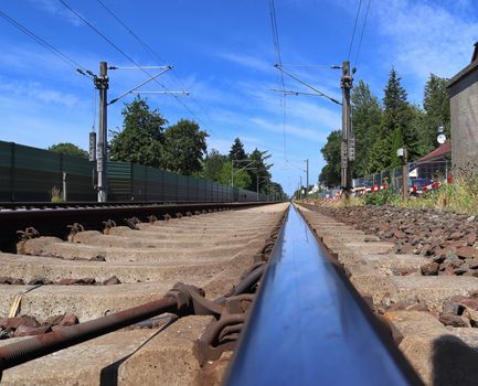 Multiple railroad tracks with junctions at a railway station in a perspective view