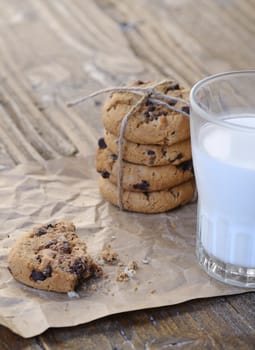 Homemade cookies with glass of milk on wooden table.