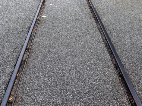 Multiple railroad tracks with junctions at a railway station in a perspective view