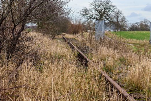 Multiple railroad tracks with junctions at a railway station in a perspective view