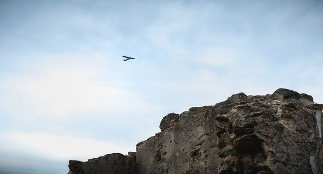 Port Joinville, France - September 16, 2018: Small passenger plane flying over Isle of Yeu near France on a fall day