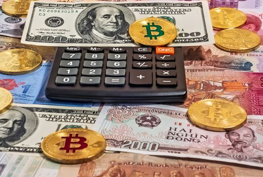Black electronic calculator one hundred dollar bill Gold Bitcoin Blockchain technology money background