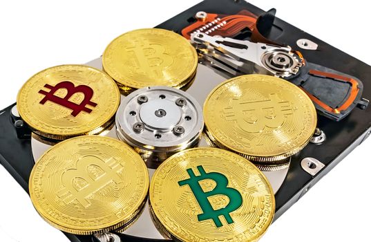 Physical Coin Cryptocurrency BTC Gold Plated Bitcoin in laptop hard disk server wallet. Crypto currency blockchain Coin virtual money concept isolated on white background.