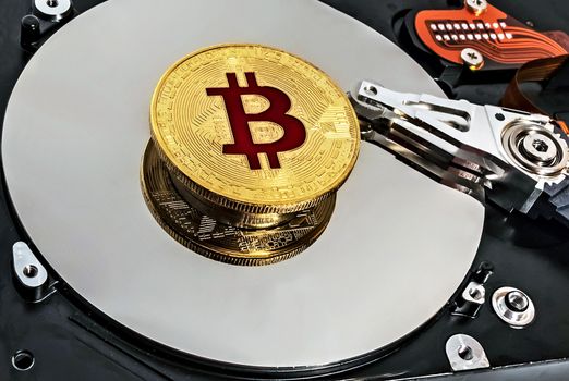 Open computer hard disk drive HDD background BTC Gold Plated Bitcoin Coin network concept wallet