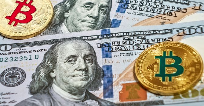 Gold bitcoin coin one hundred U.S. dollars bills background cryptocurrency mining concept. Macro portrait of Benjamin Franklin