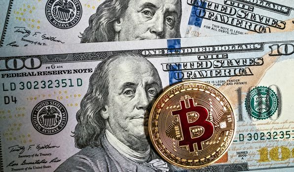 Gold bitcoin coin Macro portrait of Benjamin Franklin of U.S. dollar bills money american background cryptocurrency mining concept.