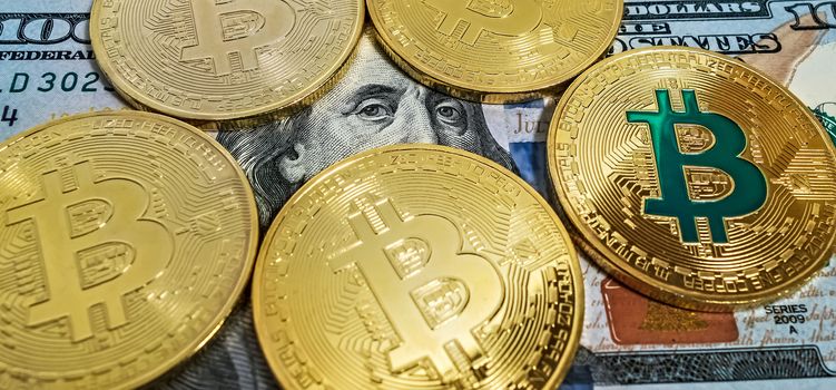 Gold bitcoin coin one hundred dollars bills. Macro portrait of Benjamin Franklin background cryptocurrency mining concept.