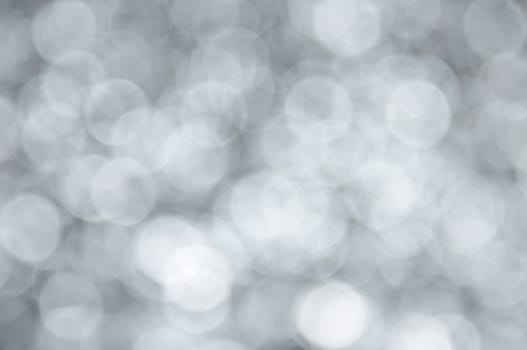 Silver colored abstract background with bokeh, for the new year and christmas