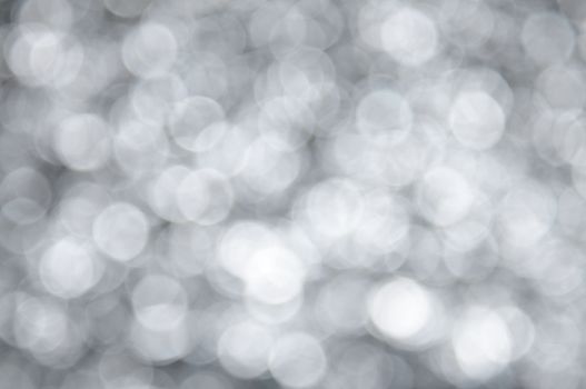 Silver colored abstract background with bokeh, for the new year and christmas