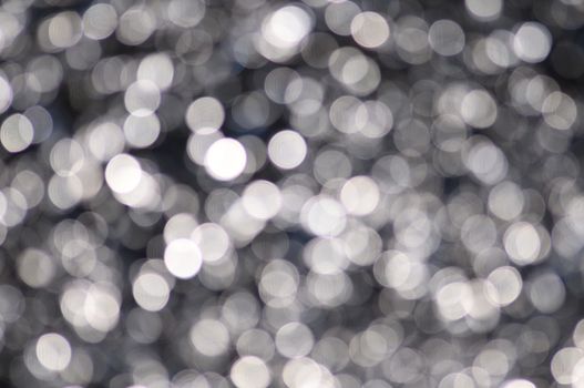 Black,white,silver,chrome colored abstract background with bokeh, for the new year and christmas