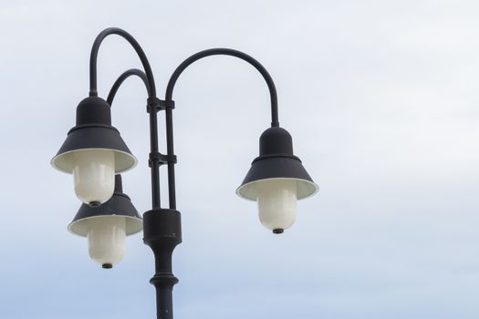 Three street lamp on blue sky background