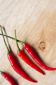 Red fresh chili on wood desk. Food background. Cooking