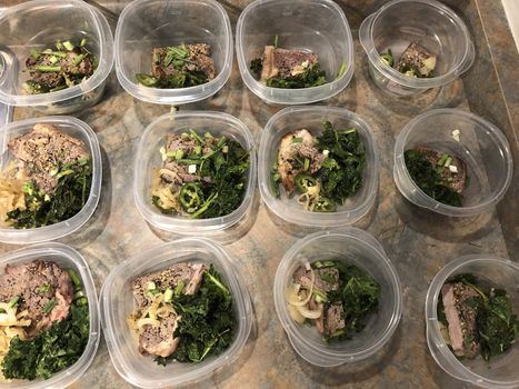 Meal prep. Stack of home cooked roast chicken dinners in containers ready to be frozen for later use as quick and easy ready meals.