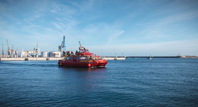 Sete, France - January 4, 2019: tourists sailing boat in the harbor to visit the city on a winter day