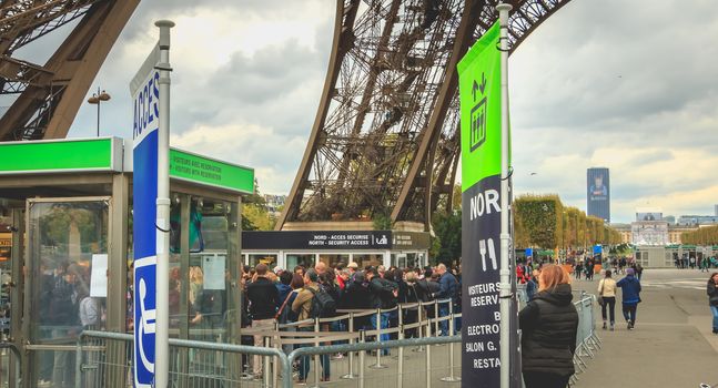 Paris, France - October 8, 2017: Waiting atmosphere around a worm of entry for the visitors of the tower Effeil on a fall day