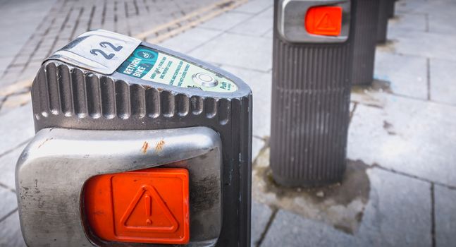 Dublin, Ireland - February 11, 2019: Detail of a shared public bike station Just Eat dublinbikes in the city center on a winter day