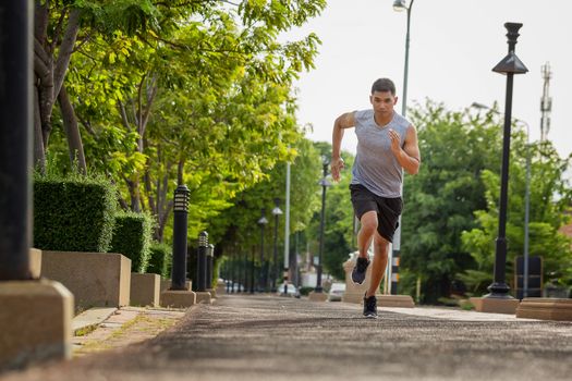 Portrait of handsome man running in the park in early morning. Healthy concept