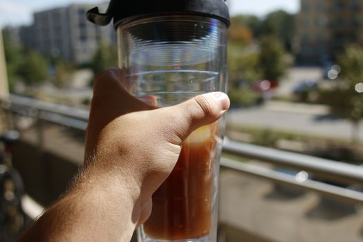 Freddo espresso coffee in front of a pool - cold coffee - summer vacation concept. Still life of freddo espresso coffee in front of a pool - cold coffee - summer