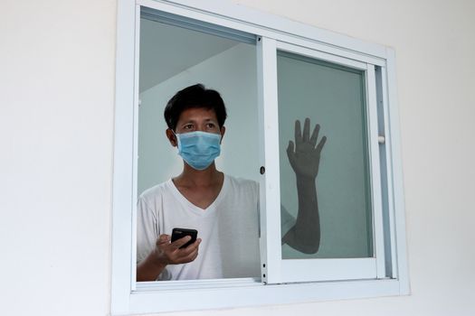 Man in isolation at home for coronavirus outbreak (COVID-19), Quarantine to prevent the spread of the coronavirus (COVID-19)